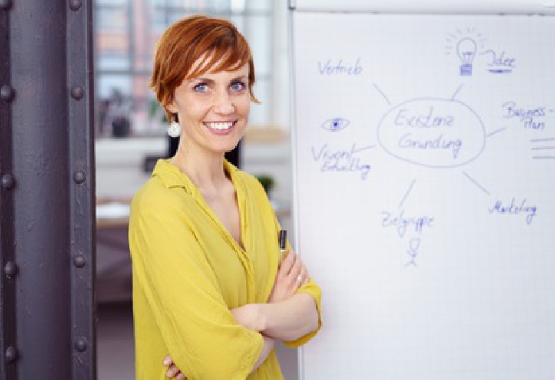 Frau steht vor Smartboard