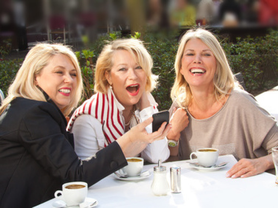 Drei Frauen sitzen in Café